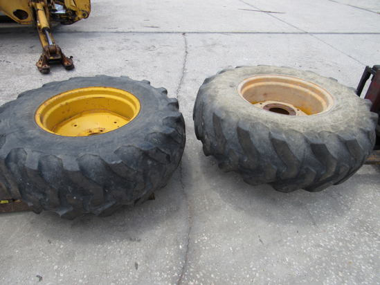 Picture of 2 John Deere AT309102 Wheels 24x15L w/ Firestone 16.9-24 Tires off 300D Backhoe
