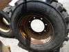Picture of 2 John Deere AT178499 AT309105 Wheels 16.5x9.75 w/ Carlisle 12-16.5 Tires off 300D Backhoe