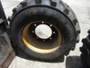 Picture of 2 John Deere AT178499 AT309105 Wheels 16.5x9.75 w/ Carlisle 12-16.5 Tires off 300D Backhoe